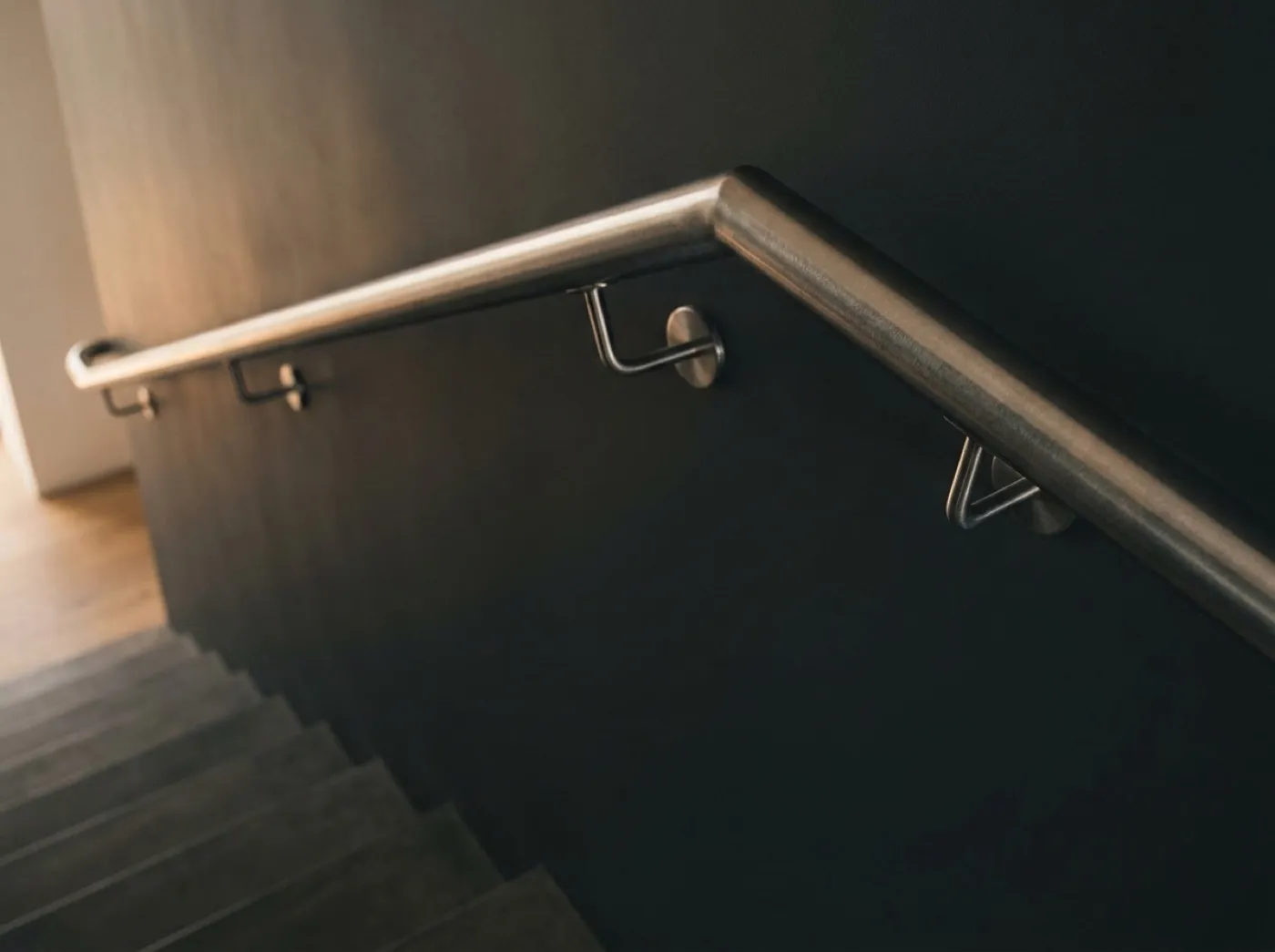 Brushed stainless steel handrail on a staircase