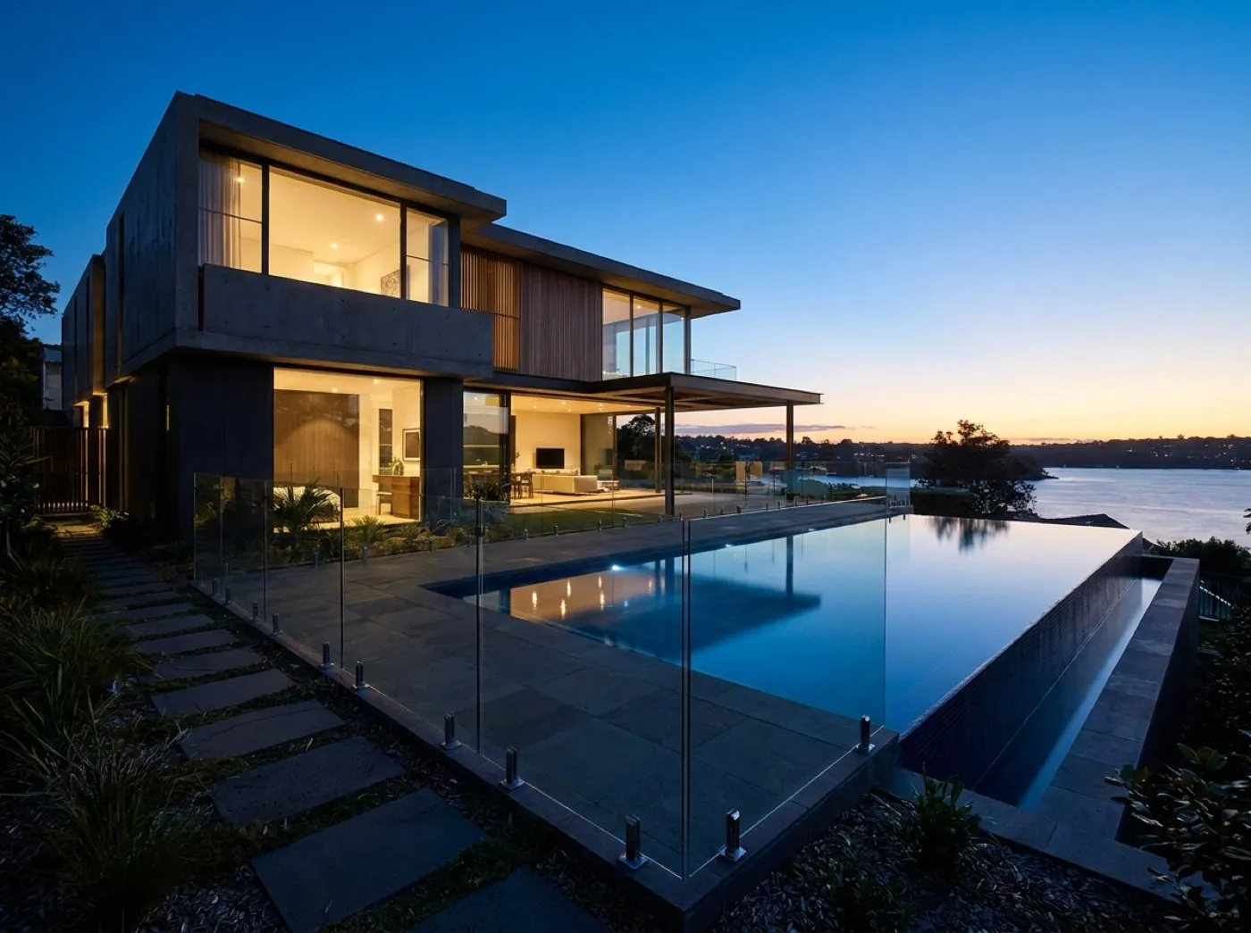 Frameless glass pool fence at a waterfront home